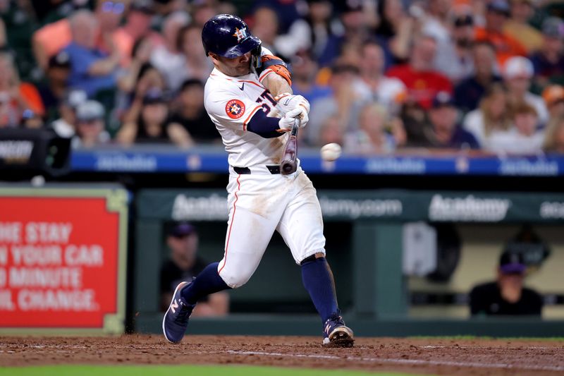 Jun 26, 2024; Houston, Texas, USA; Houston Astros second baseman Jose Altuve (27) hits an RBI single against the Colorado Rockies during the fifth inning at Minute Maid Park. Mandatory Credit: Erik Williams-USA TODAY Sports
