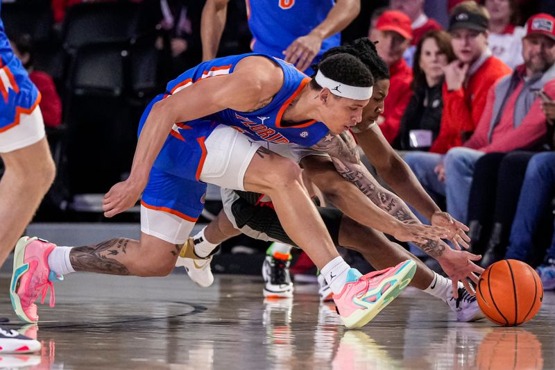 Feb 17, 2024; Athens, Georgia, USA; Florida Gators guard Riley Kugel (2) and Georgia Bulldogs guard Silas Demary Jr. (4) dive for the ball during the first half at Stegeman Coliseum. Mandatory Credit: Dale Zanine-USA TODAY Sports