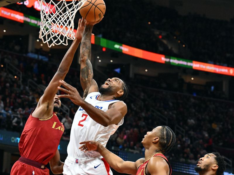 CLEVELAND, OHIO - JANUARY 29: Kawhi Leonard #2 of the LA Clippers shoots over Evan Mobley #4 Isaac Okoro #35 and Donovan Mitchell #45 of the Cleveland Cavaliers during the third quarter at Rocket Mortgage Fieldhouse on January 29, 2024 in Cleveland, Ohio. The Cavaliers defeated the Clippers 118-108. NOTE TO USER: User expressly acknowledges and agrees that, by downloading and or using this photograph, User is consenting to the terms and conditions of the Getty Images License Agreement. (Photo by Jason Miller/Getty Images)