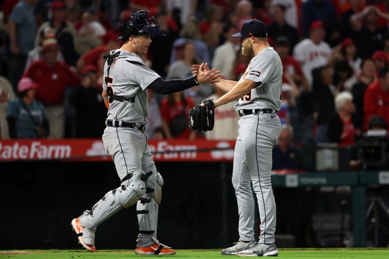 Sep 16, 2023; Anaheim, California, USA;  Detroit Tigers catcher Carson Kelly (15) and Detroit Tigers relief pitcher Will Vest (19) celebrate a victory after defeating the Los Angeles Angels 5-4 at Angel Stadium. Mandatory Credit: Kiyoshi Mio-USA TODAY Sports