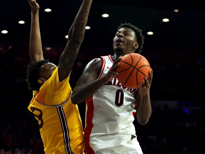 Feb 17, 2024; Tucson, Arizona, USA; Arizona Wildcats guard Jaden Bradley (0) shoots a basket against Arizona State Sun Devils center Shawn Phillips Jr. (9) during the second half at McKale Center. Mandatory Credit: Zachary BonDurant-USA TODAY Sports