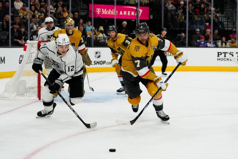 Dec 28, 2023; Las Vegas, Nevada, USA; Vegas Golden Knights defenseman Alex Pietrangelo (7) and Los Angeles Kings left wing Trevor Moore (12) skate for the puck during the third period at T-Mobile Arena. Mandatory Credit: Lucas Peltier-USA TODAY Sports