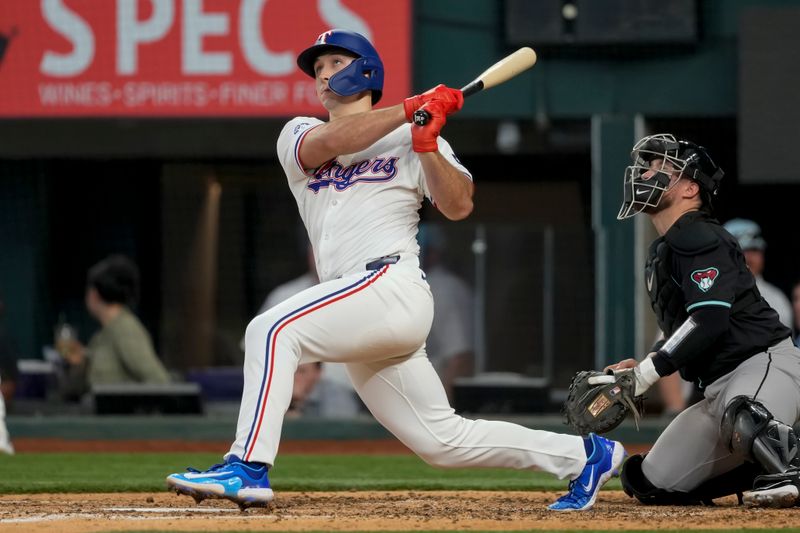 May 29, 2024; Arlington, Texas, USA; Texas Rangers left fielder Wyatt Langford (36) follows through on his RBI single against the Arizona Diamondbacks during the eighth inning at Globe Life Field. Mandatory Credit: Jim Cowsert-USA TODAY Sports