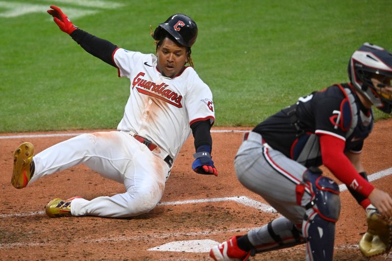 Apr 30, 2025; Cleveland, Ohio, USA; Cleveland Guardians third baseman Jose Ramirez (11) scores against Minnesota Twins catcher Ryan Jeffers (27) in the seventh inning at Progressive Field. Mandatory Credit: David Richard-Imagn Images