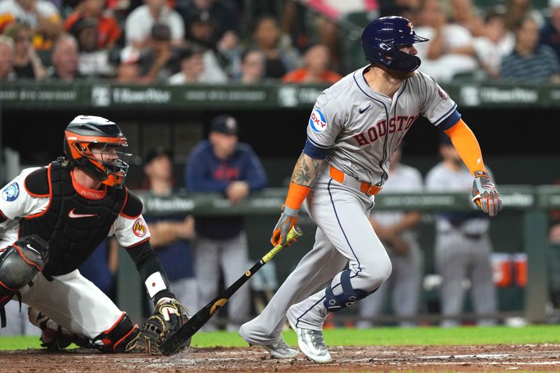 Aug 22, 2024; Baltimore, Maryland, USA; Houston Astros outfielder Ben Gamel (12) singles to drive in a run during the fourth inning against the Baltimore Orioles at Oriole Park at Camden Yards. Mandatory Credit: Mitch Stringer-USA TODAY Sports