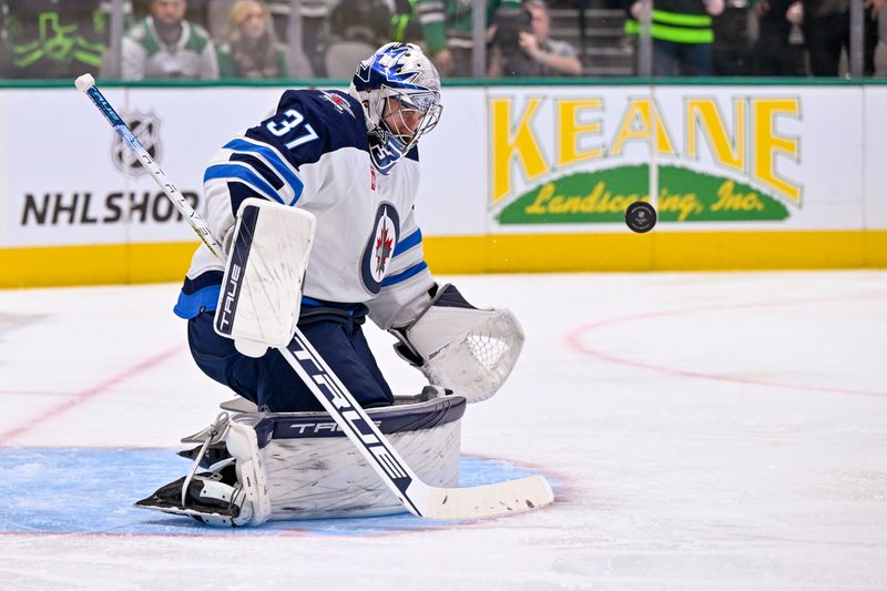 Oct 17, 2022; Dallas, Texas, USA; Winnipeg Jets goaltender Connor Hellebuyck (37) stops a Dallas Stars shot during the second period at the American Airlines Center. Mandatory Credit: Jerome Miron-USA TODAY Sports