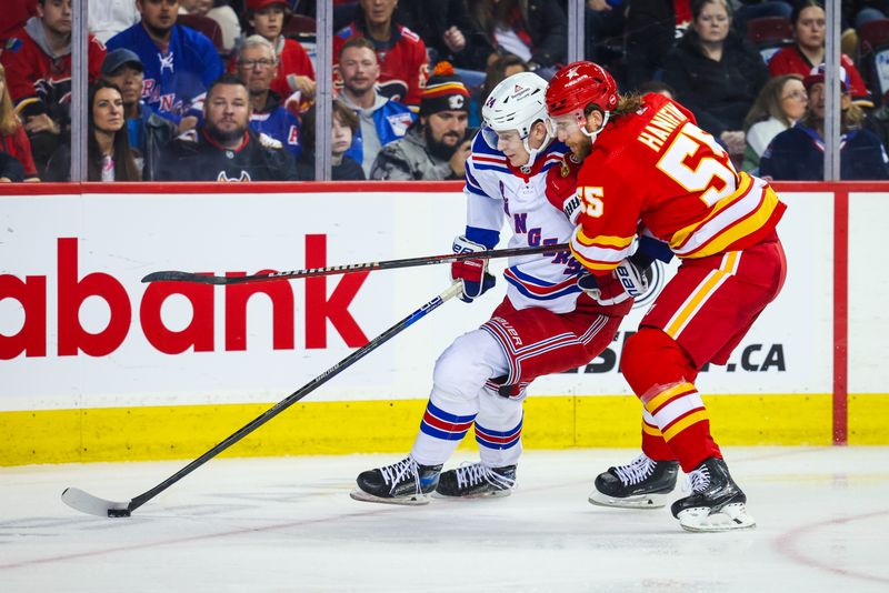 Oct 24, 2023; Calgary, Alberta, CAN; New York Rangers right wing Kaapo Kakko (24) and Calgary Flames defenseman Noah Hanifin (55) battle for the puck during the third period at Scotiabank Saddledome. Mandatory Credit: Sergei Belski-USA TODAY Sports