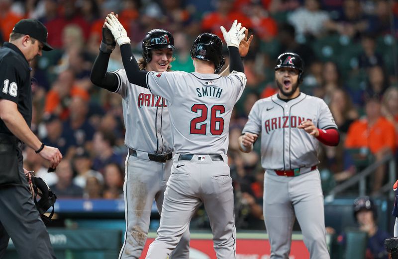 Sep 8, 2024; Houston, Texas, USA; Arizona Diamondbacks left fielder Pavin Smith (26) celebrates with center fielder Jake McCarthy (31) after hitting a home run during the second inning against the Houston Astros at Minute Maid Park. Mandatory Credit: Troy Taormina-Imagn Images