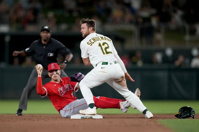 May 21, 2025; West Sacramento, California, USA; Athletics shortstop Max Schuemann (12) reacts after being called out at second base next to Los Angeles Angels shortstop Zach Neto (9) in the fifth inning at Sutter Health Park. Mandatory Credit: Cary Edmondson-Imagn Images