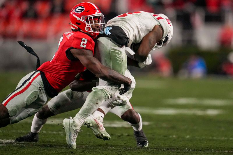 Nov 11, 2023; Athens, Georgia, USA; Georgia Bulldogs linebacker Smael Mondon Jr. (2) tackles Mississippi Rebels running back Quinshon Judkins (4) during the first half at Sanford Stadium. Mandatory Credit: Dale Zanine-USA TODAY Sports