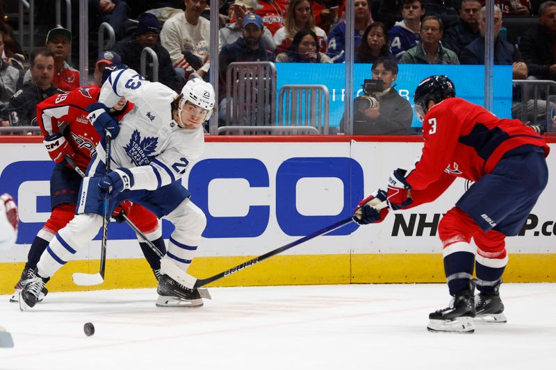 Nov 13, 2024; Washington, District of Columbia, USA; Toronto Maple Leafs left wing Matthew Knies (23) battle for the puck with Washington Capitals defenseman Matt Roy (3) in the second period at Capital One Arena. Mandatory Credit: Geoff Burke-Imagn Images