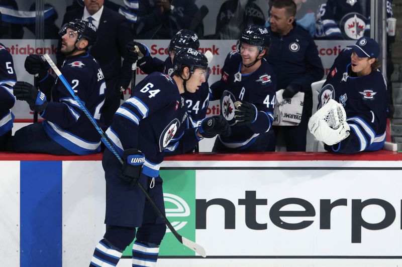Oct 18, 2025; Winnipeg, Manitoba, CAN; Winnipeg Jets defenseman Logan Stanley (64) celebrates his goal against the Nashville Predators in the third period at Canada Life Centre. Mandatory Credit: James Carey Lauder-Imagn Images
