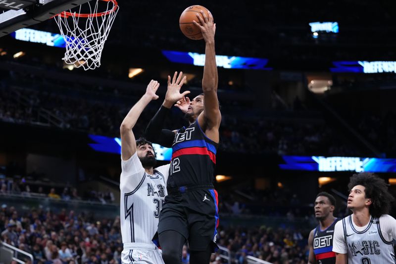 ORLANDO, FLORIDA - NOVEMBER 23: Tobias Harris #12 of the Detroit Pistons goes up for a shot against Goga Bitadze #35 of the Orlando Magic during the third quarter at Kia Center on November 23, 2024 in Orlando, Florida. NOTE TO USER: User expressly acknowledges and agrees that, by downloading and/or using this photograph, user is consenting to the terms and conditions of the Getty Images License Agreement. (Photo by Rich Storry/Getty Images)