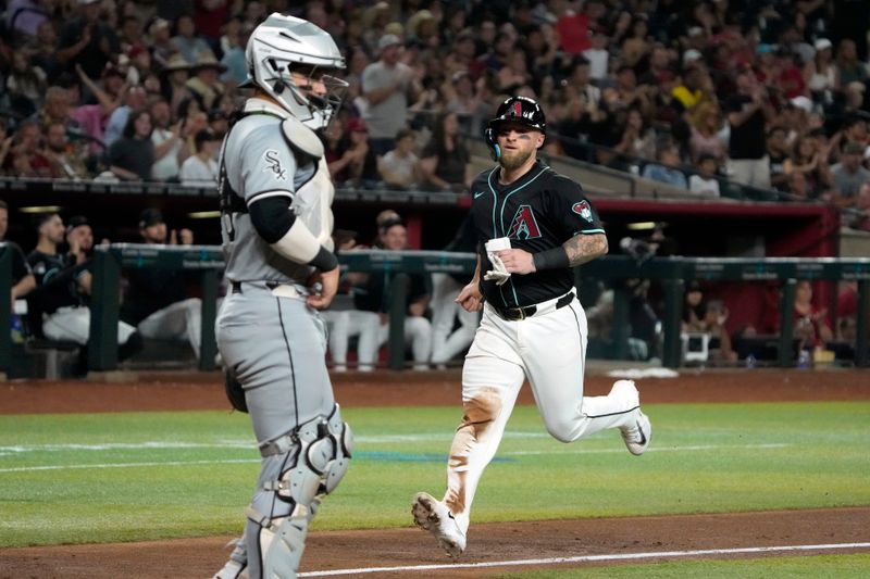 Jun 14, 2024; Phoenix, Arizona, USA; Arizona Diamondbacks catcher Tucker Barnhart (16) scores a run against the Chicago White Sox in the fourth inning at Chase Field. Mandatory Credit: Rick Scuteri-USA TODAY Sports