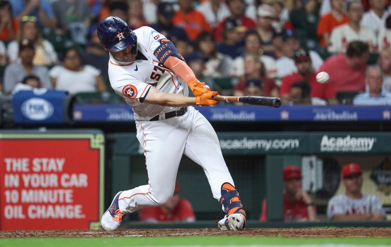 Aug 12, 2023; Houston, Texas, USA; Houston Astros left fielder Chas McCormick (20) hits a single during the eighth inning against the Los Angeles Angels at Minute Maid Park. Mandatory Credit: Troy Taormina-USA TODAY Sports