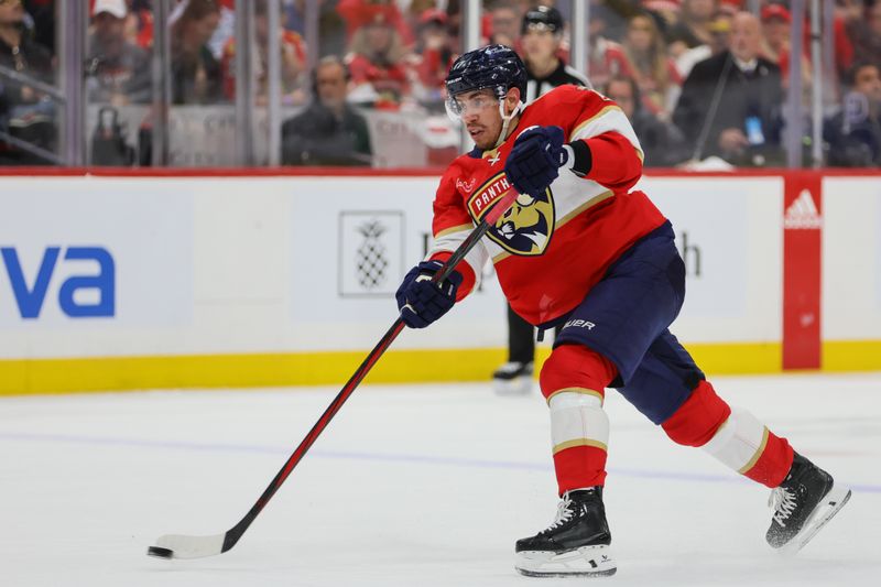 May 6, 2024; Sunrise, Florida, USA; Florida Panthers center Evan Rodrigues (17) shoots the puck against the Boston Bruins during the second period in game one of the second round of the 2024 Stanley Cup Playoffs at Amerant Bank Arena. Mandatory Credit: Sam Navarro-USA TODAY Sports