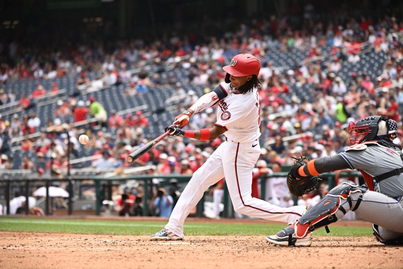 Jul 4, 2024; Washington, District of Columbia, USA; Washington Nationals shortstop CJ Abrams (5) hits the ball into play against the New York Mets during the seventh inning at Nationals Park. Mandatory Credit: Rafael Suanes-USA TODAY Sports