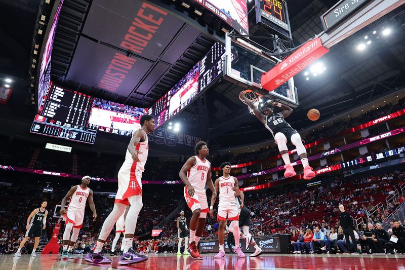 HOUSTON, TEXAS - OCTOBER 17: Sidy Cissoko #25 of the San Antonio Spurs dunks the ball over the Houston Rockets during the second half of a preseason game at Toyota Center on October 17, 2024 in Houston, Texas. NOTE TO USER: User expressly acknowledges and agrees that, by downloading and or using this photograph, User is consenting to the terms and conditions of the Getty Images License Agreement. (Photo by Alex Slitz/Getty Images)