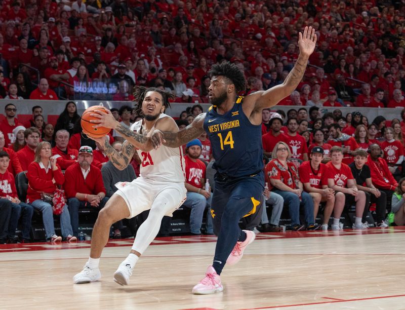 Jan 6, 2024; Houston, Texas, USA;Houston Cougars guard Emanuel Sharp (21) dribbles against West Virginia Mountaineers guard Seth Wilson (14) in the first half  at Fertitta Center. Mandatory Credit: Thomas Shea-USA TODAY Sports