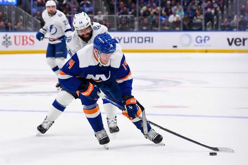 Apr 6, 2023; Elmont, New York, USA; New York Islanders center Bo Horvat (14) skates with the puck defended by Tampa Bay Lightning left wing Pat Maroon (14) during the second period at UBS Arena. Mandatory Credit: Dennis Schneidler-USA TODAY Sports