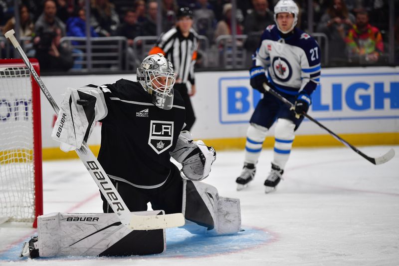 Dec 13, 2023; Los Angeles, California, USA; Los Angeles Kings goaltender Cam Talbot (39) blocks a shot against the Winnipeg Jets during the third period at Crypto.com Arena. Mandatory Credit: Gary A. Vasquez-USA TODAY Sports