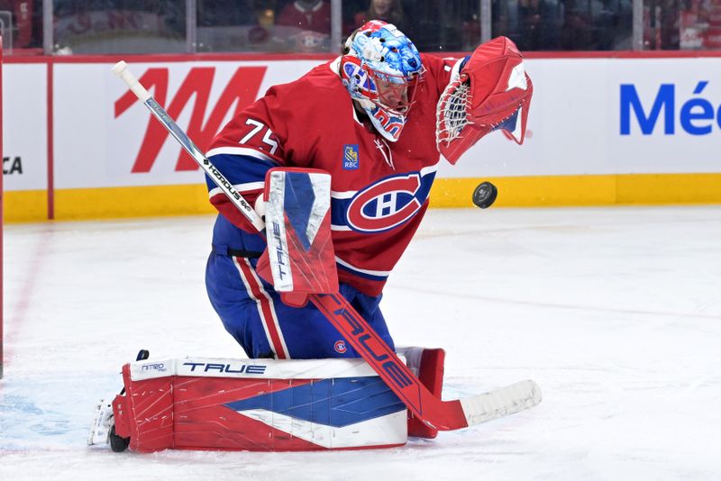 Mar 24, 2026; Montreal, Quebec, CAN; Montreal Canadiens goalie Jakub Dobes (75) makes a save during the second period of the game against the Carolina Hurricanes at the Bell Centre. Mandatory Credit: Eric Bolte-Imagn Images