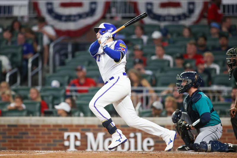 May 20, 2023; Atlanta, Georgia, USA; Atlanta Braves third baseman Austin Riley (27) hits a single against the Seattle Mariners in the sixth inning at Truist Park. Mandatory Credit: Brett Davis-USA TODAY Sports