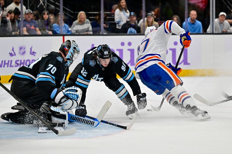 Nov 29, 2024; Salt Lake City, Utah, USA; Edmonton Oilers center Connor McDavid (97) attempted a shot against Utah Hockey Club center Logan Cooley (92) and goaltender Karel Vejmelka (70) during the third period at the Delta Center. Mandatory Credit: Christopher Creveling-Imagn Images