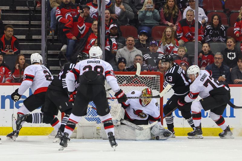 Mar 23, 2024; Newark, New Jersey, USA; Ottawa Senators goaltender Joonas Korpisalo (70) makes a save on New Jersey Devils center Nico Hischier (13) during the third period at Prudential Center. Mandatory Credit: Ed Mulholland-USA TODAY Sports