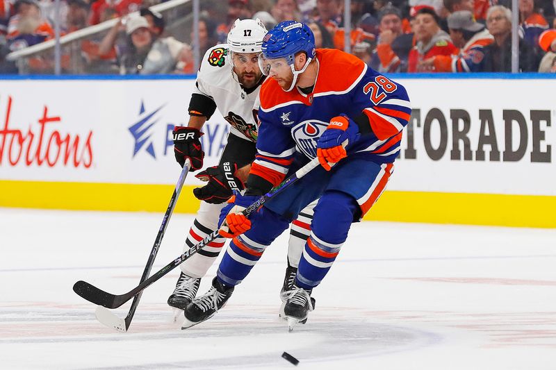 Oct 12, 2024; Edmonton, Alberta, CAN; Edmonton Oilers forward Connor Brown (28) and Chicago Blackhawks forward Nick Foligno (17) battle for a loose puck during the second period at Rogers Place. Mandatory Credit: Perry Nelson-Imagn Images