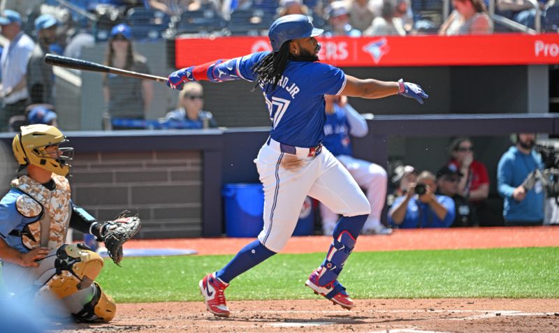 May 19, 2024; Toronto, Ontario, CAN;  Toronto Blue Jays first baseman Vladimir Guerrero Jr. (27) hits a single against the Tampa Bay Rays in the fourth inning at Rogers Centre. Mandatory Credit: Dan Hamilton-USA TODAY Sports