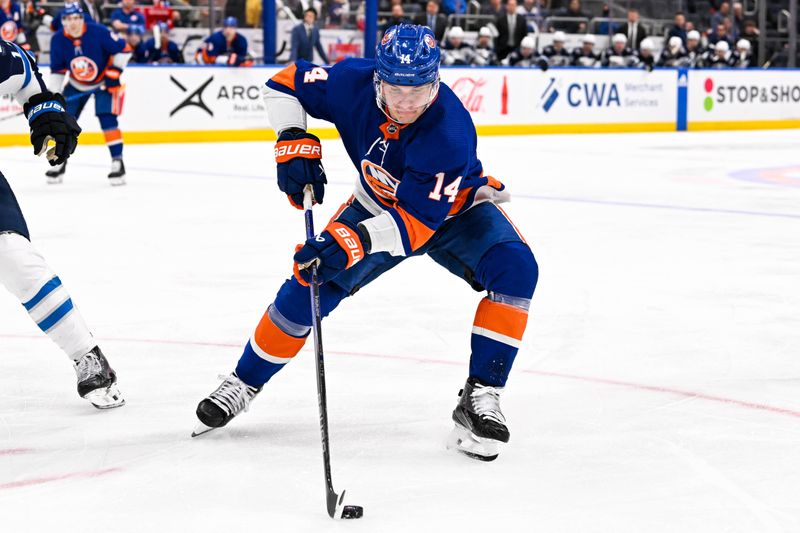 Mar 23, 2024; Elmont, New York, USA;  New York Islanders center Bo Horvat (14) controls the puck against the Winnipeg Jets during the second period at UBS Arena. Mandatory Credit: Dennis Schneidler-USA TODAY Sports