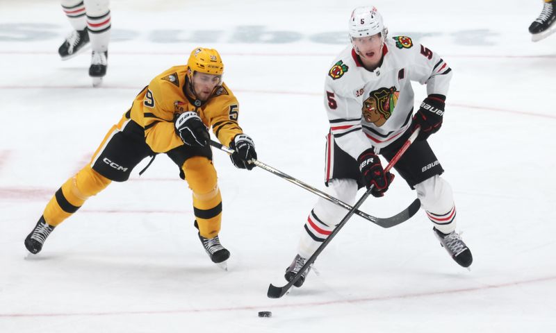 Jan 29, 2026; Pittsburgh, Pennsylvania, USA;  Chicago Blackhawks defenseman Connor Murphy (5) moves the puck against Pittsburgh Penguins right wing Egor Chinakhov (59) during the third period at PPG Paints Arena. Mandatory Credit: Charles LeClaire-Imagn Images