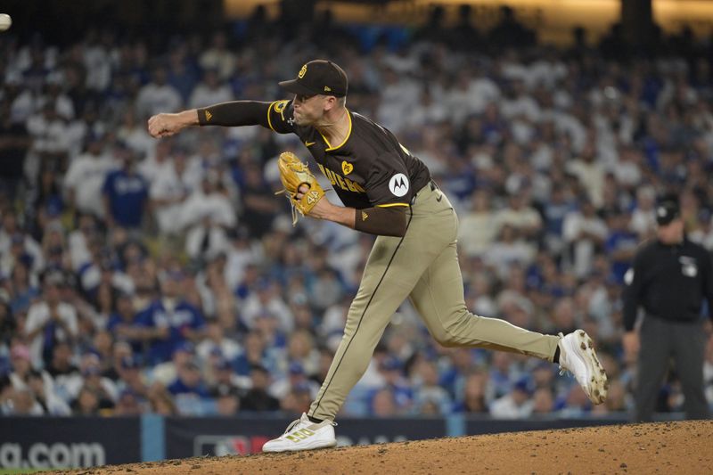 Oct 11, 2024; Los Angeles, California, USA; San Diego Padres pitcher Jason Adam (40) pitches in the eighth inning against the Los Angeles Dodgers during game five of the NLDS for the 2024 MLB Playoffs at Dodger Stadium. Mandatory Credit: Jayne Kamin-Oncea-Imagn Images