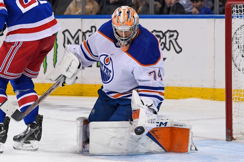 Dec 22, 2023; New York, New York, USA;  Edmonton Oilers goaltender Stuart Skinner (74) makes a save against the New York Rangers during the second period at Madison Square Garden. Mandatory Credit: Dennis Schneidler-USA TODAY Sports