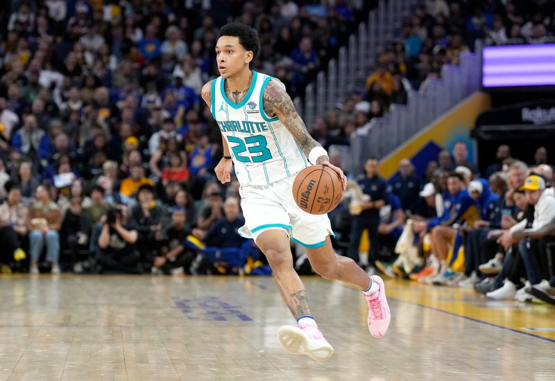 SAN FRANCISCO, CALIFORNIA - FEBRUARY 23: Tre Mann #23 of the Charlotte Hornets dribbles the ball against the Golden State Warriors during the fourth quarter of an NBA basketball game at Chase Center on February 23, 2024 in San Francisco, California. NOTE TO USER: User expressly acknowledges and agrees that, by downloading and or using this photograph, User is consenting to the terms and conditions of the Getty Images License Agreement. (Photo by Thearon W. Henderson/Getty Images)