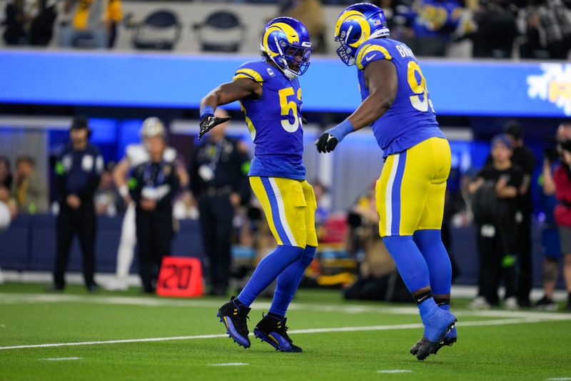 Los Angeles Rams linebacker Ernest Jones (53) celebrates with defensive tackle Bobby Brown III (95) after defensive stop during the second half of an NFL football game against the New Orleans Saints, Thursday, Dec. 21, 2023, in Inglewood, Calif. (AP Photo/Ashley Landis)