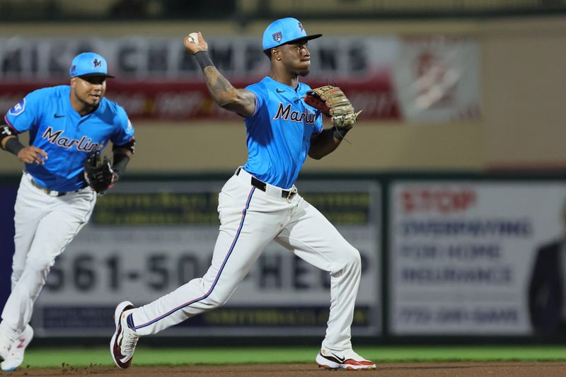 Mar 8, 2024; Jupiter, Florida, USA; Miami Marlins shortstop Tim Anderson (7) throws to first base to retire New York Mets right fielder DJ Stewart (not pictured) during the first inning at Roger Dean Chevrolet Stadium. Mandatory Credit: Sam Navarro-USA TODAY Sports