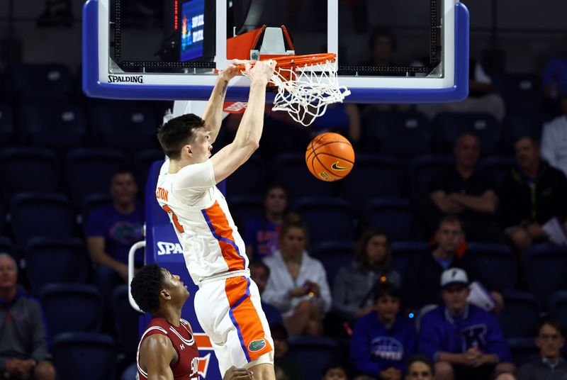 Jan 25, 2023; Gainesville, Florida, USA; Florida Gators forward Colin Castleton (12) dunks against the South Carolina Gamecocks during the first half at Exactech Arena at the Stephen C. O'Connell Center. Mandatory Credit: Kim Klement-USA TODAY Sports