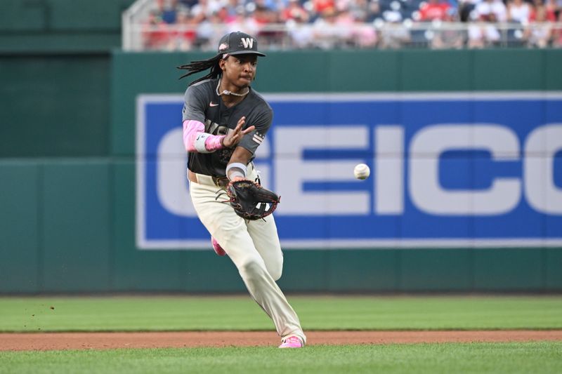 Jul 5, 2024; Washington, District of Columbia, USA; Washington Nationals shortstop CJ Abrams (5) fields a ground ball against the St. Louis Cardinals during the fourth inning at Nationals Park. Mandatory Credit: Rafael Suanes-USA TODAY Sports