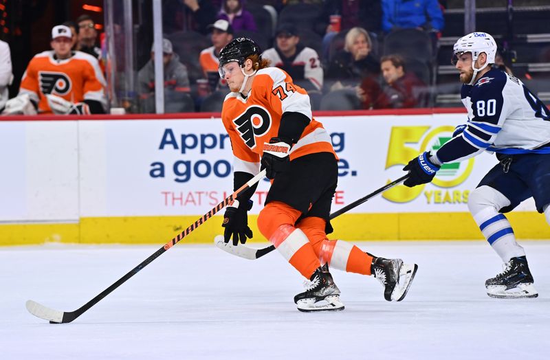 Jan 22, 2023; Philadelphia, Pennsylvania, USA; Philadelphia Flyers right wing Owen Tippett (74) pushes the puck past Winnipeg Jets left wing Pierre-Luc Dubois (80) in the first period at Wells Fargo Center. Mandatory Credit: Kyle Ross-USA TODAY Sports