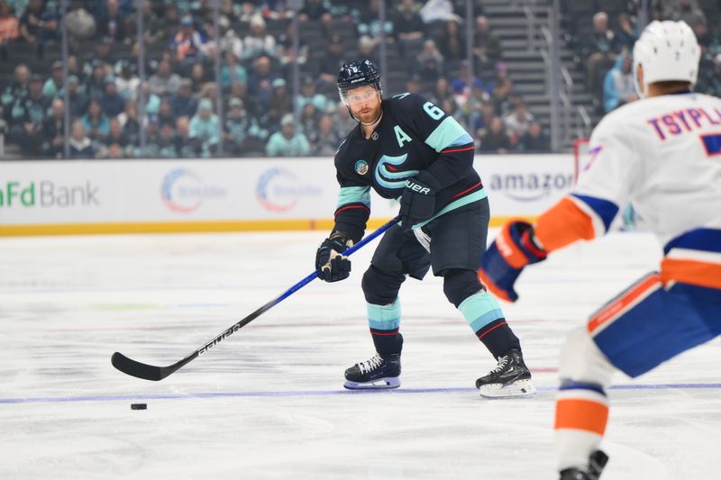 Nov 16, 2024; Seattle, Washington, USA; Seattle Kraken defenseman Adam Larsson (6) looks to pass the puck against the New York Islanders during the first period at Climate Pledge Arena. Mandatory Credit: Steven Bisig-Imagn Images