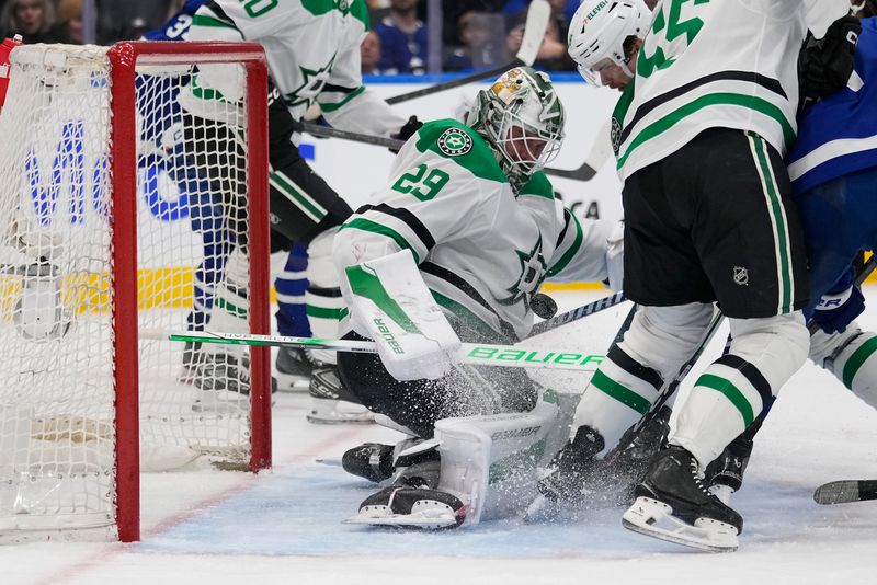 Jan 14, 2025; Toronto, Ontario, CAN; Dallas Stars goaltender Jake Oettinger (29) makes a save against the Toronto Maple Leafs during the third period at Scotiabank Arena. Mandatory Credit: John E. Sokolowski-Imagn Images