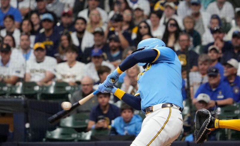 Jun 7, 2025; Milwaukee, Wisconsin, USA; Milwaukee Brewers first base Rhys Hoskins (12) drives in a run against the San Diego Padres in the eighth inning at American Family Field. Mandatory Credit: Michael McLoone-Imagn Images