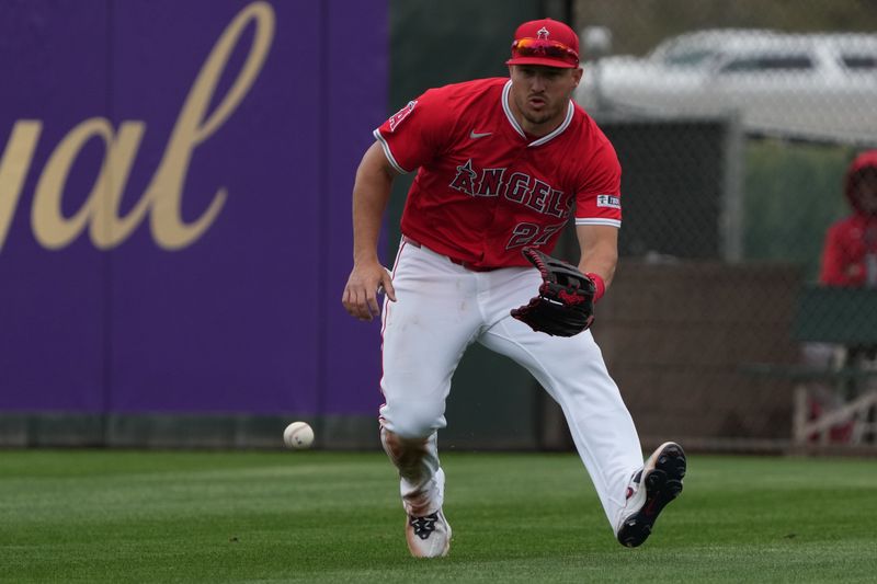 Mar 14, 2025; Tempe, Arizona, USA; Los Angeles Angels outfielder Mike Trout (27) fields the ball against the Kansas City Royals in the third inning at Tempe Diablo Stadium. Mandatory Credit: Rick Scuteri-Imagn Images