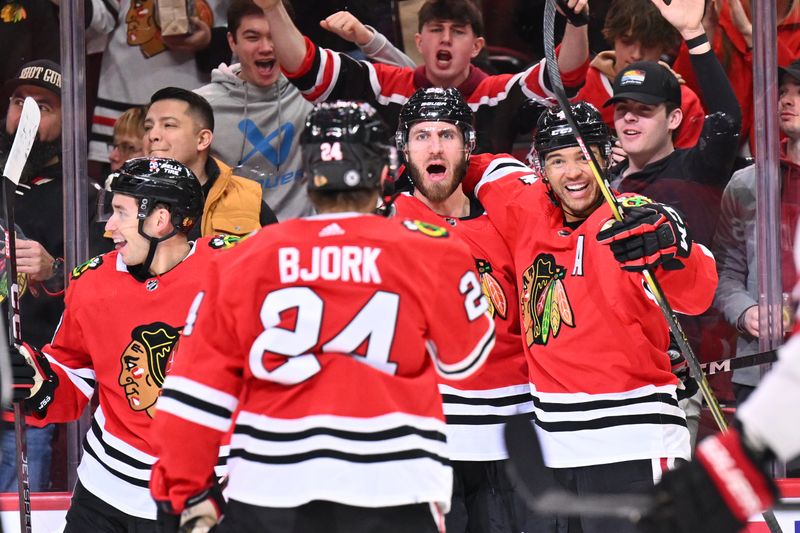 Mar 6, 2023; Chicago, Illinois, USA;  Chicago Blackhawks defenseman Seth Jones (4) celebrates with defensman Jarred Tinordi (25) and forward Anders Bjork (24) after scoring a goal in the second period against the Ottawa Senators at United Center. Mandatory Credit: Jamie Sabau-USA TODAY Sports