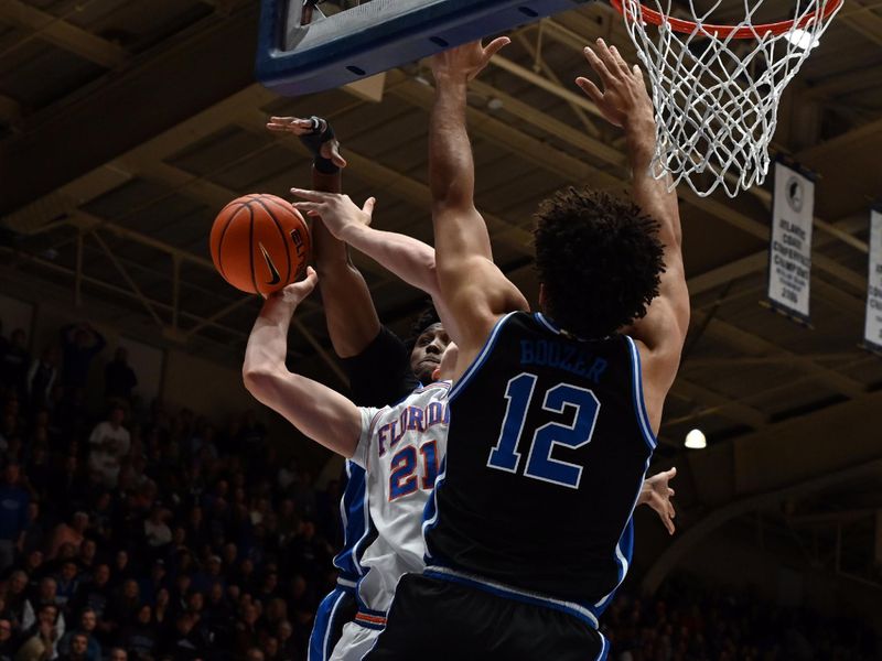 Dec 2, 2025; Durham, North Carolina, USA; Florida Gators forward/center Alex Condon (21) attempts to shoot over Duke Blue Devils forward Cameron Boozer (12) during the first half at Cameron Indoor Stadium. Mandatory Credit: Rob Kinnan-Imagn Images