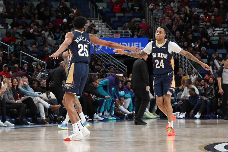 NEW ORLEANS, LA - JANUARY 17: Trey Murphy III #25 and Jordan Hawkins #24 of the New Orleans Pelicans high five during the game against the Charlotte Hornets on January 17, 2024 at the Smoothie King Center in New Orleans, Louisiana. NOTE TO USER: User expressly acknowledges and agrees that, by downloading and or using this Photograph, user is consenting to the terms and conditions of the Getty Images License Agreement. Mandatory Copyright Notice: Copyright 2024 NBAE (Photo by Layne Murdoch Jr./NBAE via Getty Images)