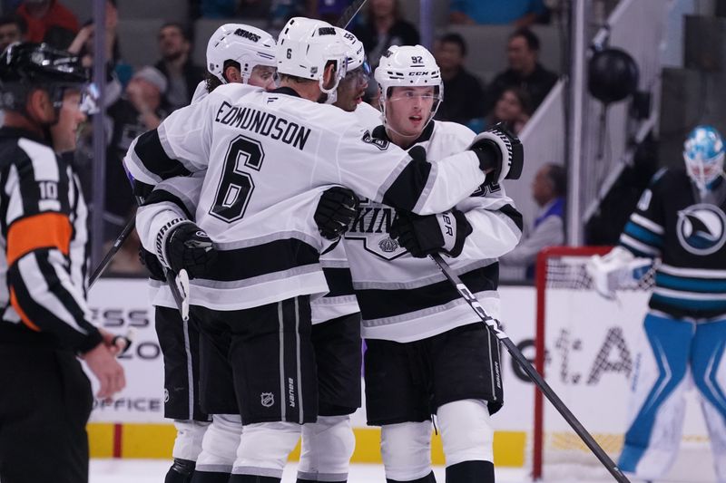 Oct 28, 2025; San Jose, California, USA; Los Angeles Kings defenseman Brandt Clarke (92) scores the winning goal against the San Jose Sharks and celebrates with defenseman Joel Edmundson (6), right winger Adrian Kempe (9), and right winger Quinton Byfield (55) in the third period at SAP Center at San Jose. Mandatory Credit: David Gonzales-Imagn Images