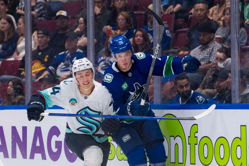 Sep 24, 2024; Vancouver, British Columbia, CAN; Seattle Kraken forward Carson Rehkopf (74) checks Vancouver Canucks defenseman Elias Pettersson (26) during the second period at Rogers Arena. Mandatory Credit: Bob Frid-Imagn Images